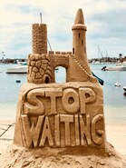 Large elaborate sand castle with text: Stop Waiting, advice for writers to avoid too much backstory.